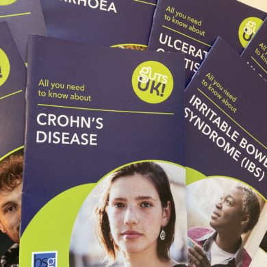 Several Gut's UK leaflets are scattered on a table. The one seen on top is the 