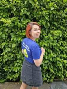 Fran in her Guts UK t-shirt looking over her shoulder