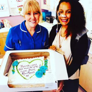 Rachael and her nurse, Jill, holding a cake Rachael got for her. The cake has written on it 'Thank you so much Jill! Love from Rachael xx'