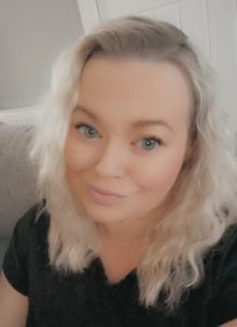 Ellie taking a selfie in a black top