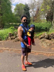 Vishal out for a walk with a baby strapped to him in a baby carrier