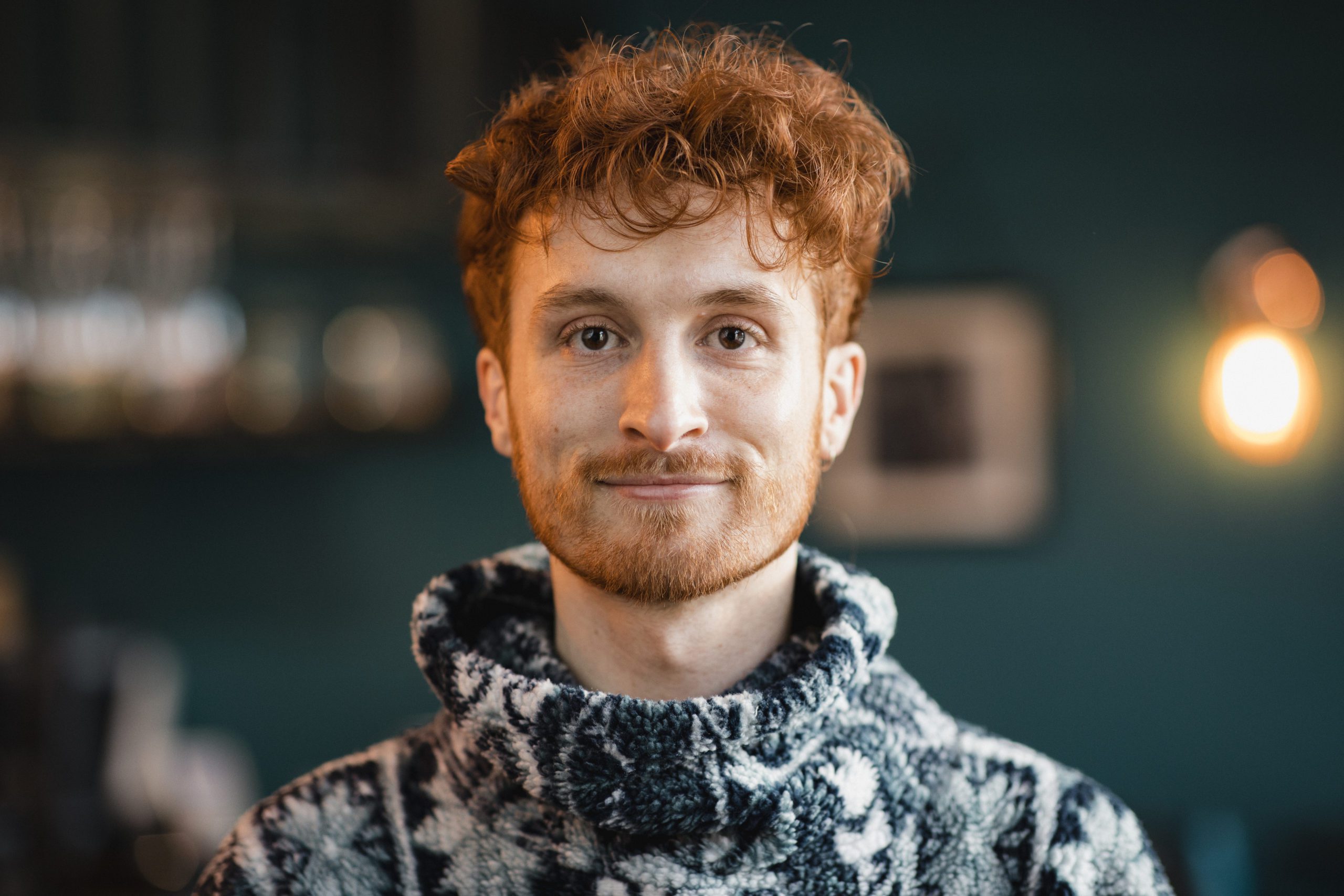 Headshot of a young man looking at the camera and smiling.
