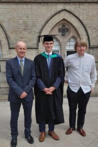 Jim stands proudly at a graduation of his family