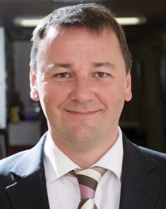 Professor Colin Rees is smiling at the camera.