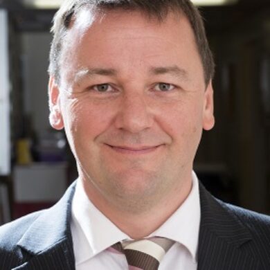 Professor Colin Rees is smiling at the camera.