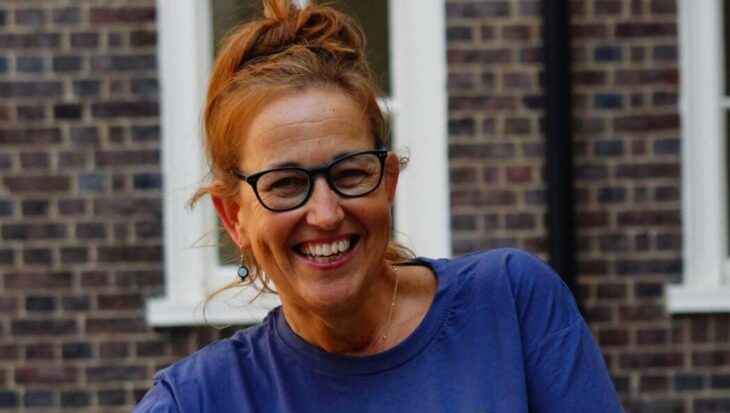 Suzanne is wearing a Guts UK t-shirt and smiling at the camera.