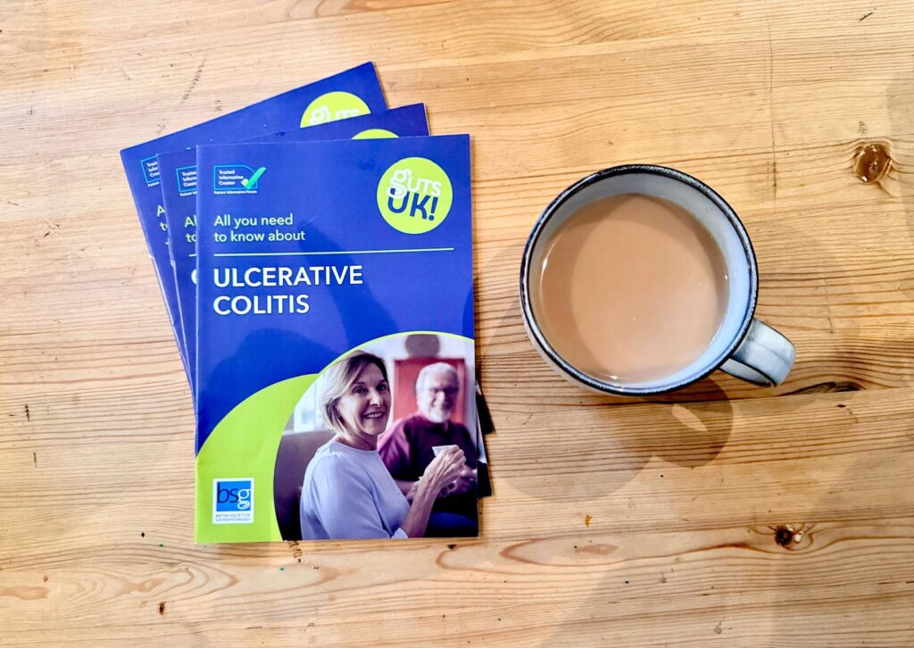 A selection of Guts UK patient information leaflets are on a table next to a cup of tea.