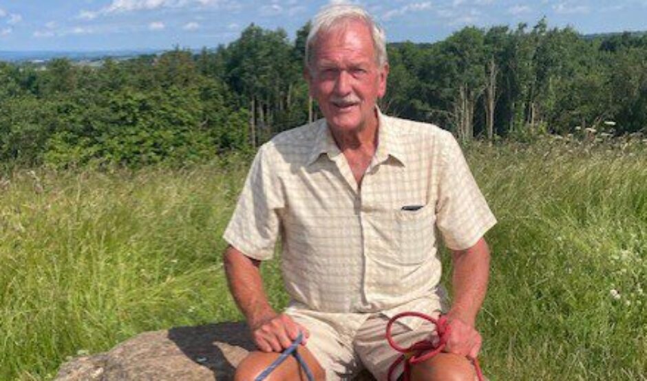 Tony takes a break on a walk with his daughter, Jen's, dogs Rocky and Molly