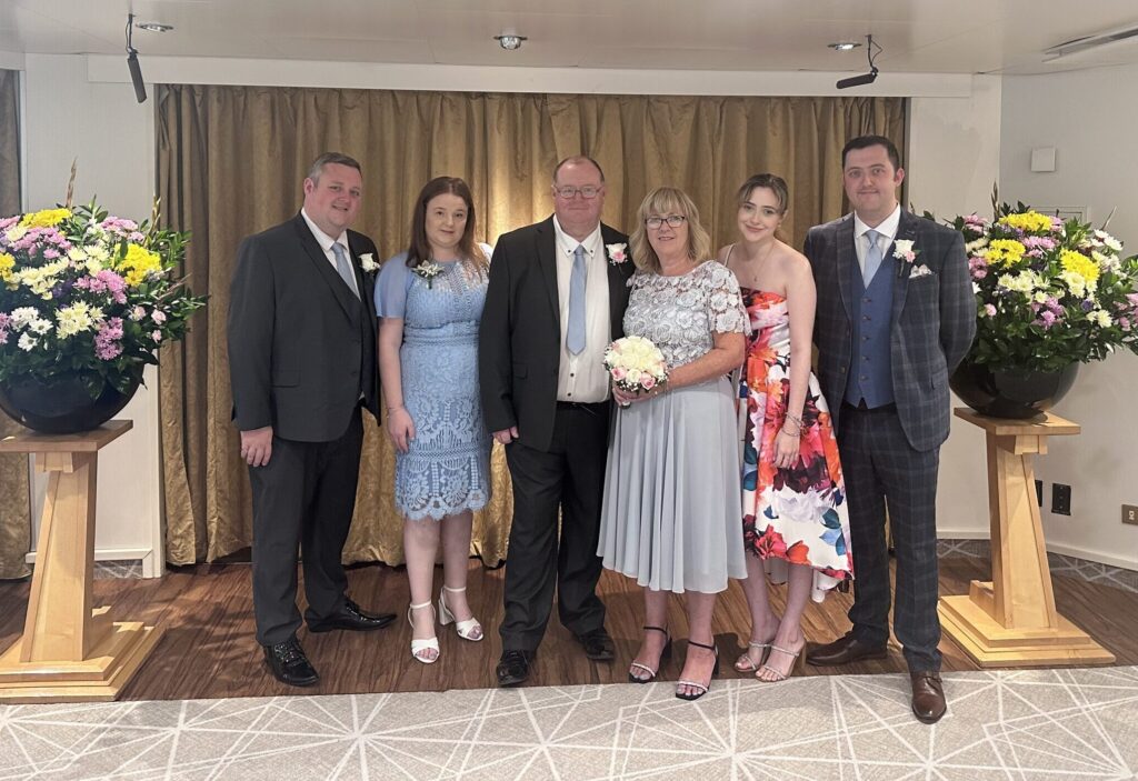 Gareth with his family in smart attire, at a celebration
