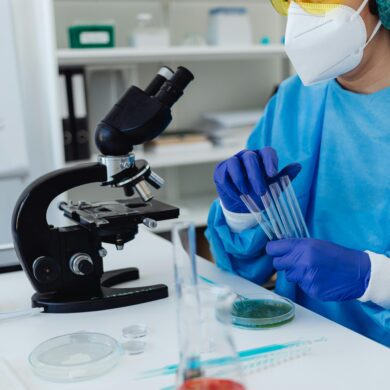 A scientist holding test tubes in a laboratory
