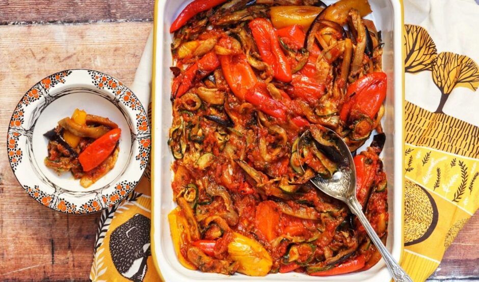 Ratatouille in a white baking dish, with peppers and vegetables in a small side dish