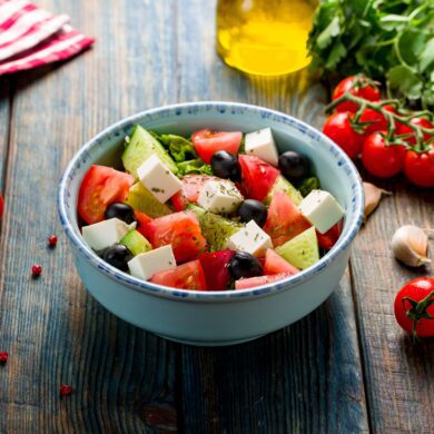 A Greek salad with feta, vegetables and olive oil.
