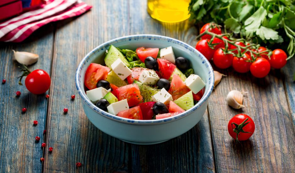 A Greek salad with feta, vegetables and olive oil.