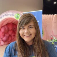 Diane Brassett, Communications Manager in a Guts UK t-shirt.