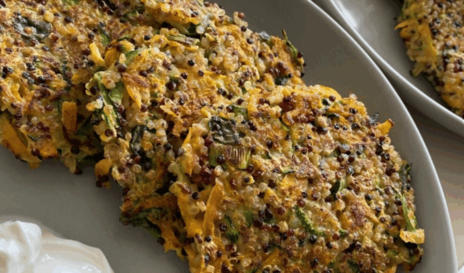 A trio of quinoa fitters on a plate, with a dollop of mayonnaise.