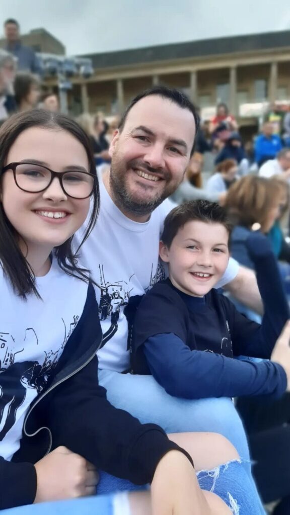 Dave with his children Isla and Toby, smiling.