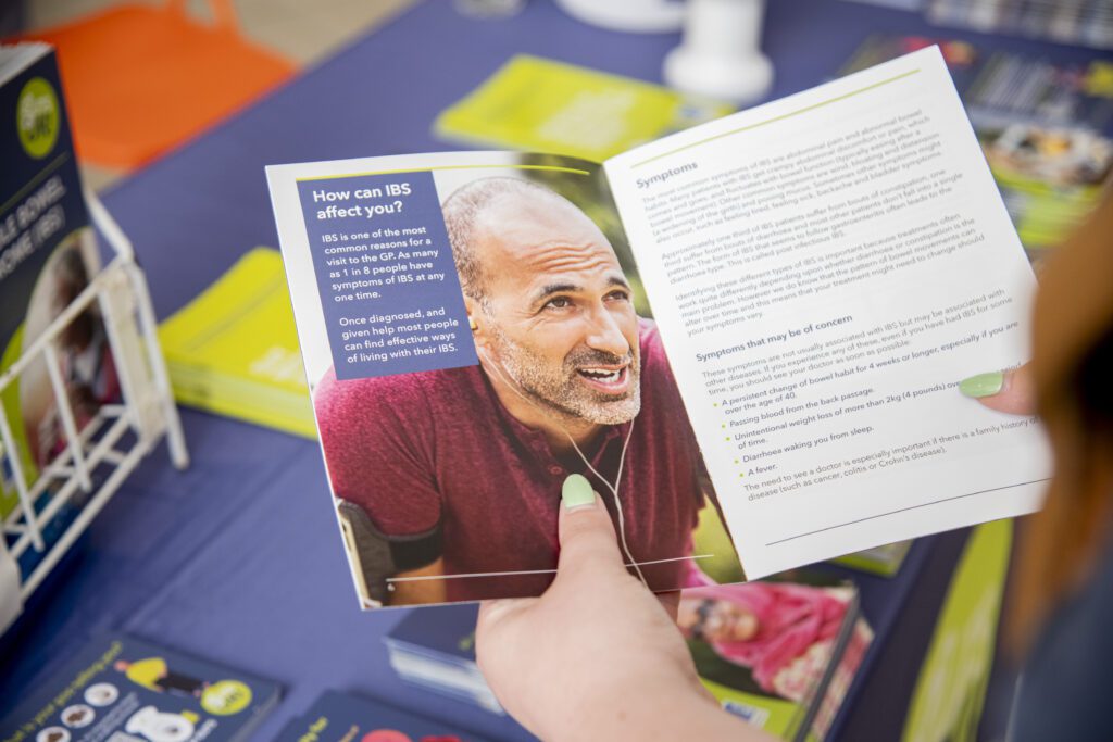 A person's hands holding a patient information leaflet.