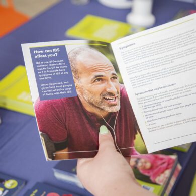 A person's hands holding a patient information leaflet.