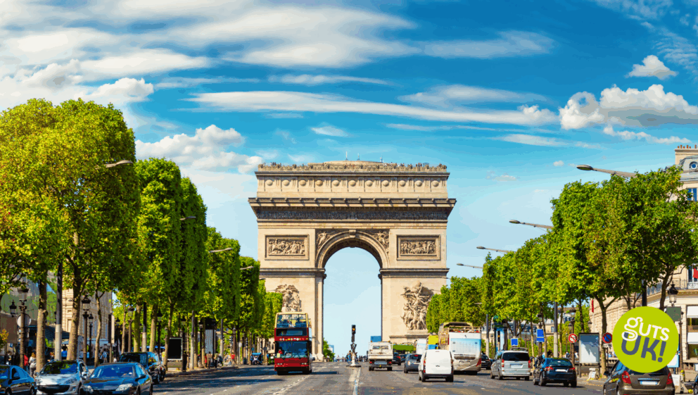 A picture of the Champs-Élysées in Paris, with The Arc De Triomphe visible in the background.