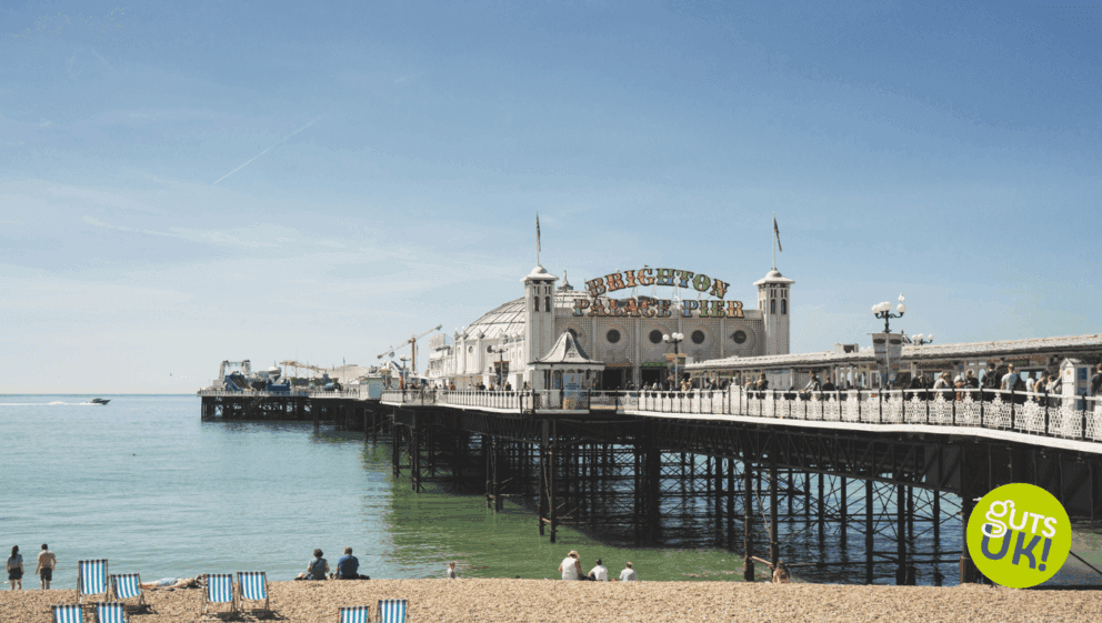 Brighton beach and sea front with Brighton Pier to the right of the shot.