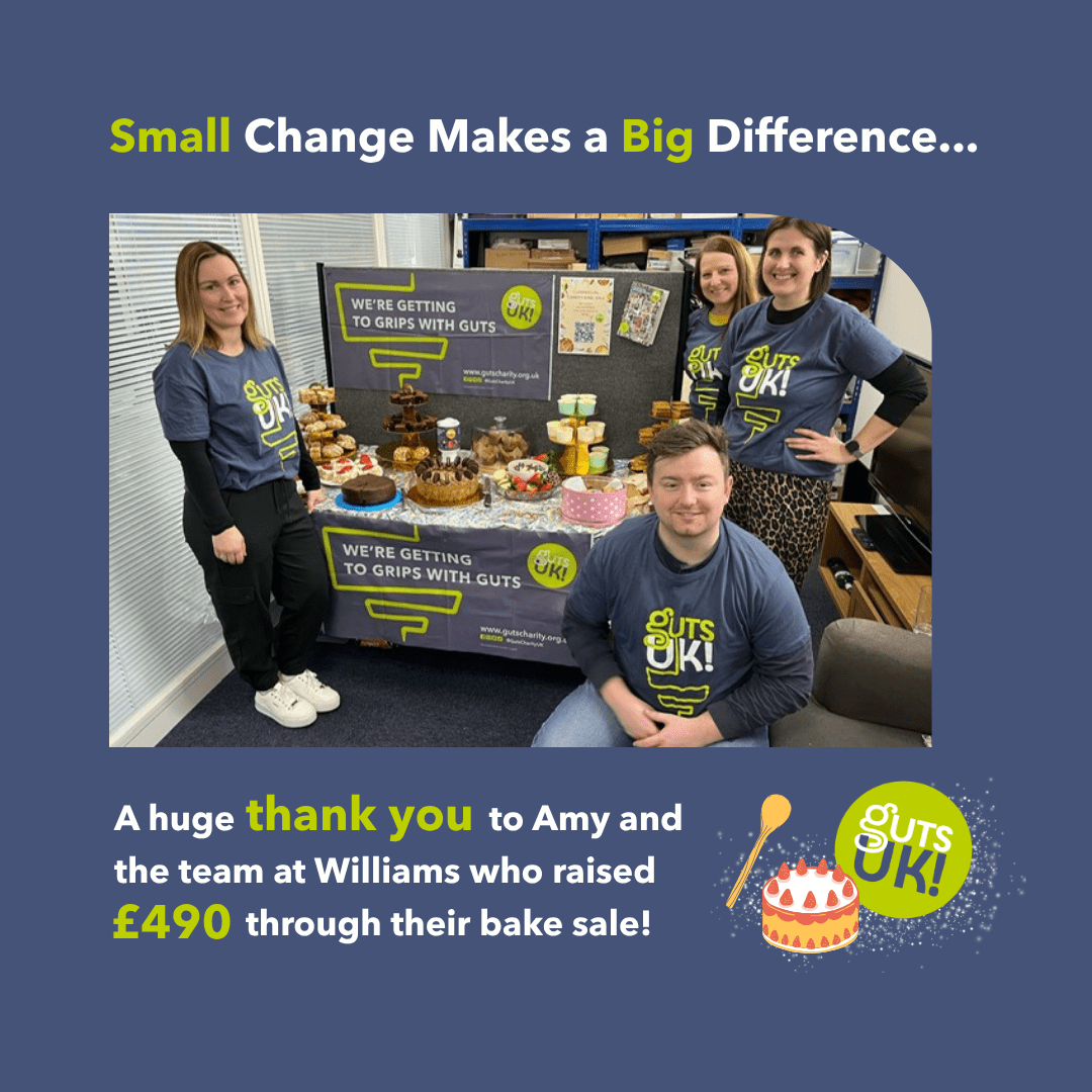 A group of colleagues from William's pumbing merchant stood next to a table full of baked goods, decorated with Guts UK branding.