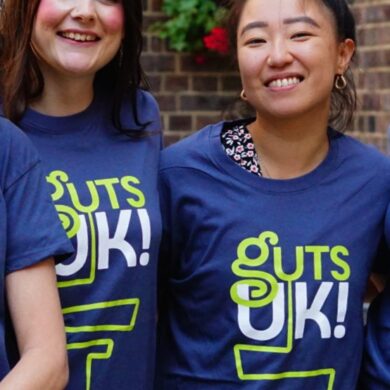 Cherylyn, Melanie, Amy, Leeona and Katie are stood smiling, wearing blue Guts UK t-shirts.