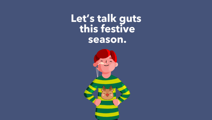 Guts UK's boy brand character is stood up with his hands on his hips, smiling. He has a feeding tube going into one nostril and three festive baubles are to the right of him. Text reads 'Let's talk guts this festive season.'