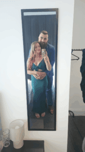 Sean pictured with his partner Rachel. They smile together in front of a mirror, taking a selfie.