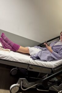 A young woman lying down in a hospital bed